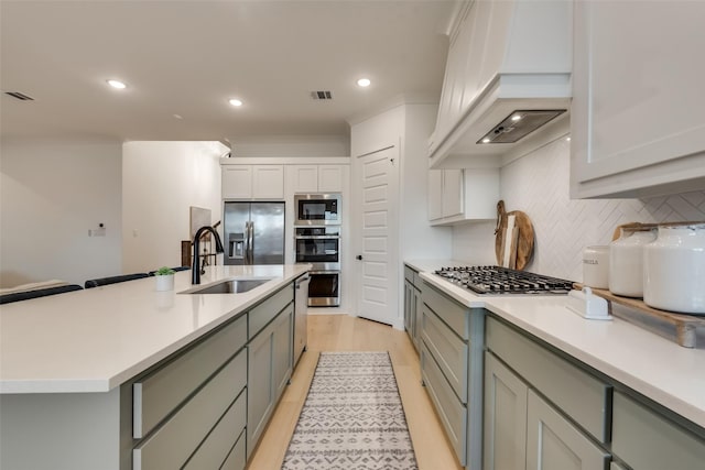12104 Fairway Meadows Dr, Fort Worth, TX 76179 - kitchen featuring premium range hood, stainless steel appliances, gray cabinetry, backsplash, and recessed lighting
