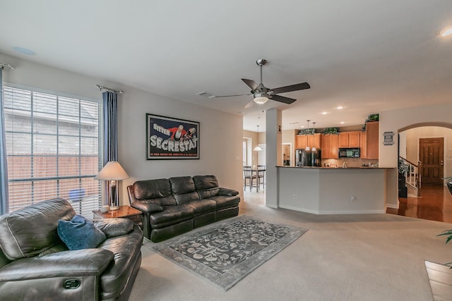 4757 Van Zandt Dr, Fort Worth, TX 76244 - carpeted living room with arched walkways, a ceiling fan, recessed lighting, and baseboards