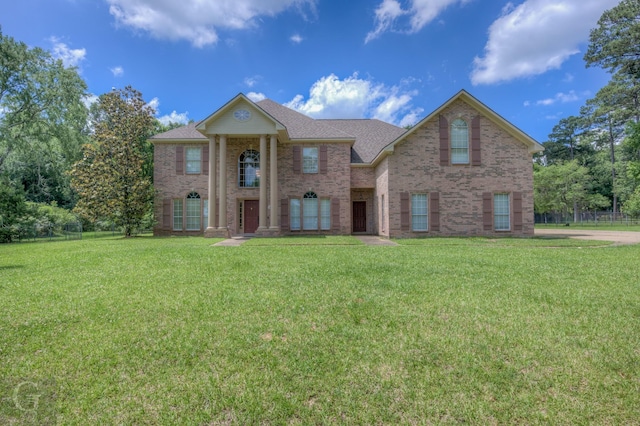 5345 Vermilion Pl, Keithville, LA 71047 - greek revival house with brick siding, a front yard, and a shingled roof