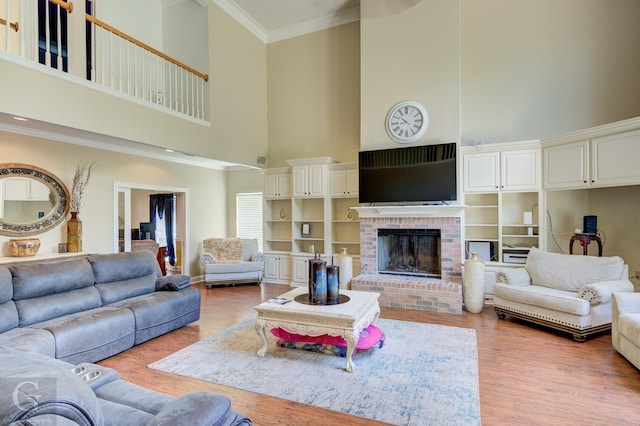 5345 Vermilion Pl, Keithville, LA 71047 - living area featuring a towering ceiling, light wood-style floors, crown molding, and a fireplace