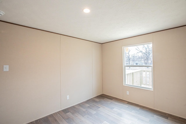 1613 Mockingbird Ln, Pelican Bay, TX 76020 - spare room featuring light wood-type flooring and crown molding