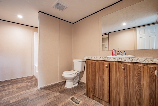 1613 Mockingbird Ln, Pelican Bay, TX 76020 - bathroom featuring toilet, vanity, wood finished floors, recessed lighting, and baseboards