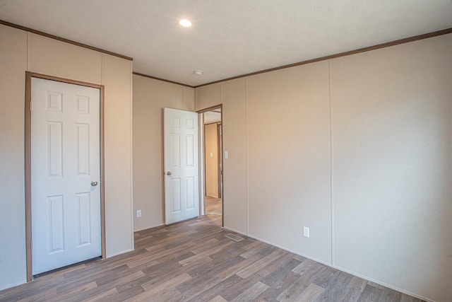 1613 Mockingbird Ln, Pelican Bay, TX 76020 - unfurnished bedroom featuring light wood finished floors, ornamental molding, and recessed lighting