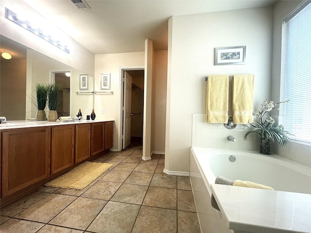 8309 Horse Whisper Ln, Fort Worth, TX 76131 - bathroom featuring double vanity, a garden tub, baseboards, and tile patterned floors