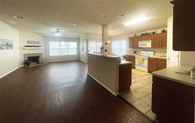 8309 Horse Whisper Ln, Fort Worth, TX 76131 - kitchen featuring white appliances, ceiling fan, plenty of natural light, and light wood-style flooring