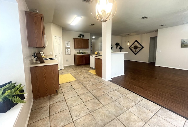 8309 Horse Whisper Ln, Fort Worth, TX 76131 - kitchen with white appliances, open floor plan, light countertops, a chandelier, and light tile patterned floors