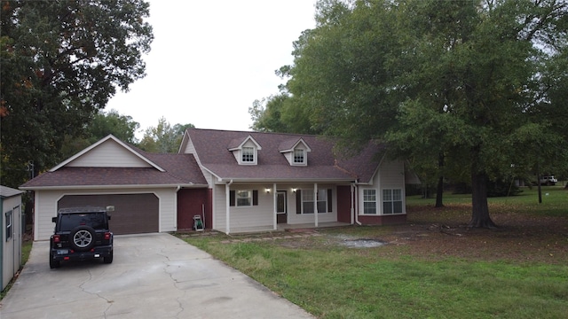 21992 Fm 226, Etoile, TX 75944 - cape cod house featuring concrete driveway, a garage, covered porch, and a front yard