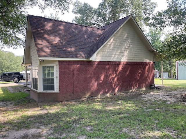 21992 Fm 226, Etoile, TX 75944 - view of side of property featuring a shingled roof, brick siding, and a lawn