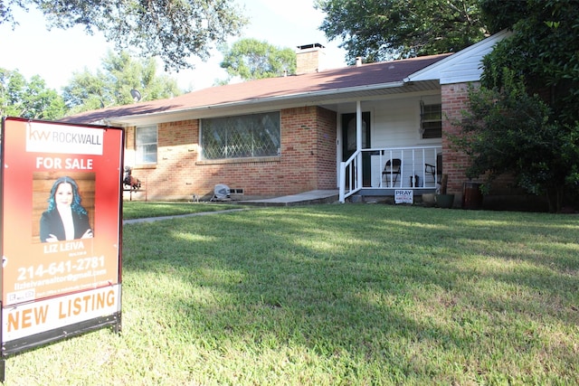 612 Ranier Cir, Garland, TX 75041 - single story home featuring covered porch, brick siding, a chimney, and a front yard