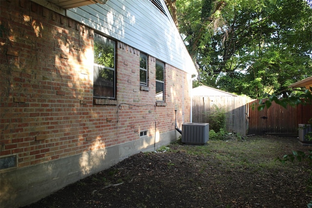 612 Ranier Cir, Garland, TX 75041 - view of side of home featuring brick siding, central AC, and crawl space