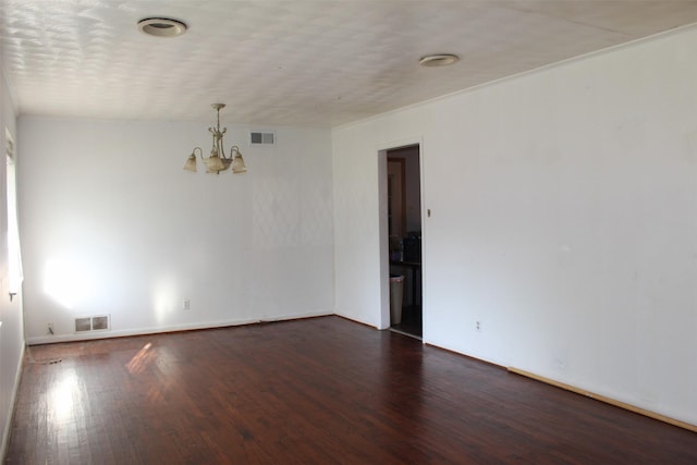 612 Ranier Cir, Garland, TX 75041 - spare room with a chandelier, dark wood-style flooring, and baseboards