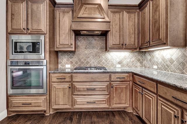 2305 Kemerton, Plano, TX 75025 - kitchen with stainless steel appliances, custom exhaust hood, dark wood finished floors, dark stone counters, and tasteful backsplash