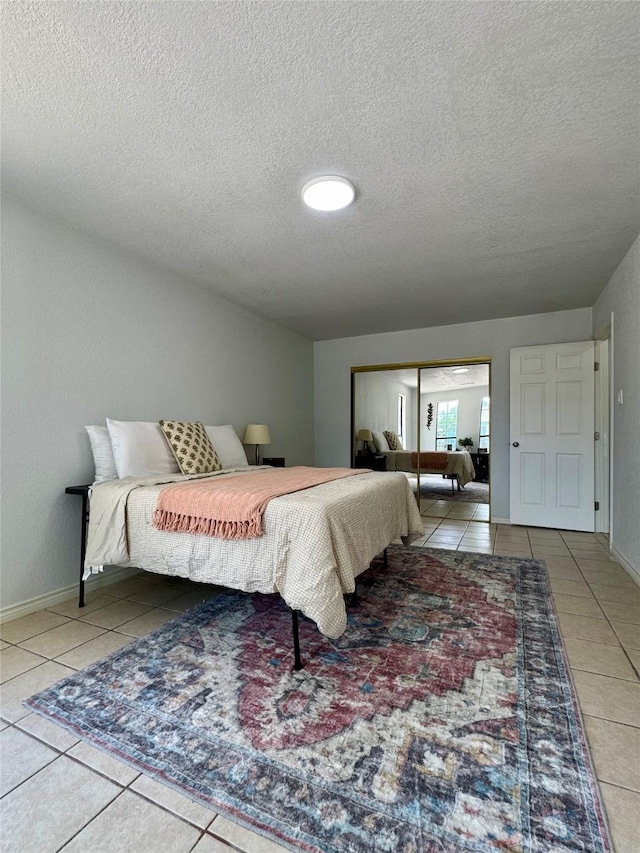 3107 Hale Ave, Fort Worth, TX 76106 - tiled bedroom featuring a textured ceiling, a closet, and baseboards