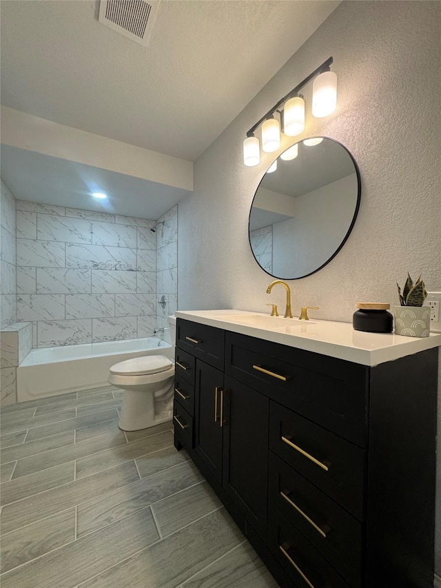 3107 Hale Ave, Fort Worth, TX 76106 - bathroom with toilet, vanity, washtub / shower combination, and a textured wall