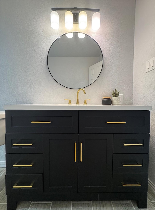 3107 Hale Ave, Fort Worth, TX 76106 - bathroom featuring vanity, a textured wall, and baseboards