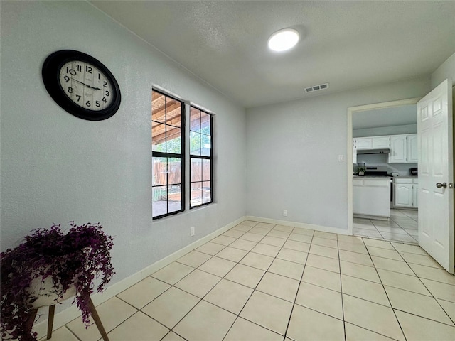 3107 Hale Ave, Fort Worth, TX 76106 - empty room with light tile patterned flooring, baseboards, and a textured wall