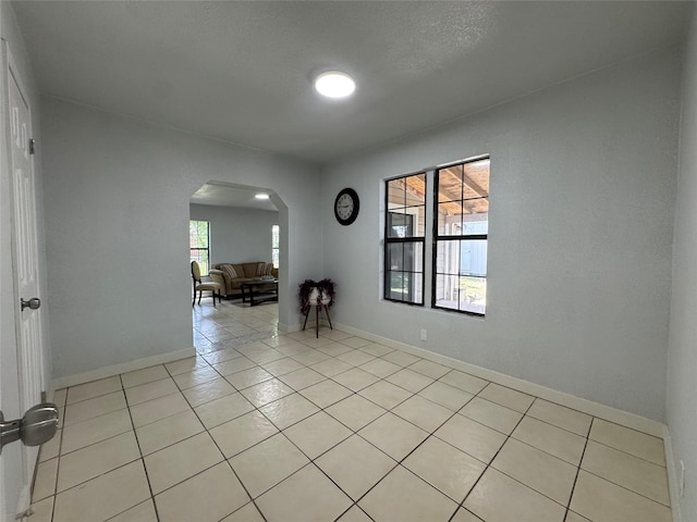 3107 Hale Ave, Fort Worth, TX 76106 - unfurnished room featuring arched walkways, light tile patterned floors, and baseboards