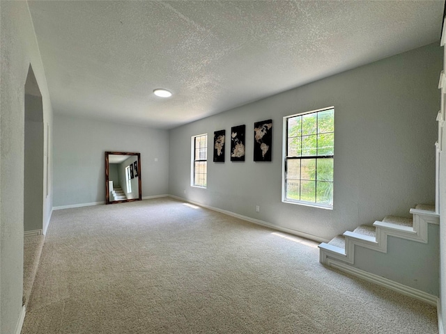 3107 Hale Ave, Fort Worth, TX 76106 - spare room with a textured ceiling, carpet floors, stairs, and baseboards