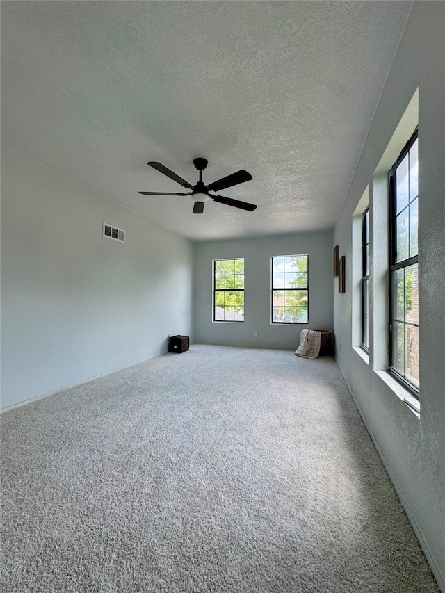 3107 Hale Ave, Fort Worth, TX 76106 - carpeted empty room with a textured ceiling and ceiling fan
