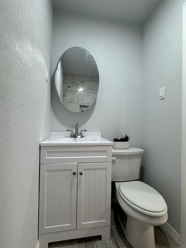3107 Hale Ave, Fort Worth, TX 76106 - bathroom with toilet, vanity, wood finished floors, and a textured wall