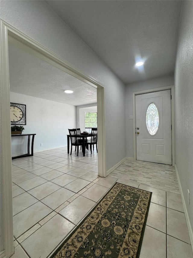 3107 Hale Ave, Fort Worth, TX 76106 - entrance foyer featuring a textured ceiling, light tile patterned floors, and baseboards