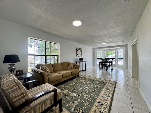 3107 Hale Ave, Fort Worth, TX 76106 - living room featuring light tile patterned floors, a textured ceiling, and baseboards