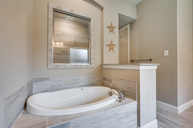 9820 Surveyor Rd, Little Elm, TX 75068 - bathroom with a garden tub and baseboards