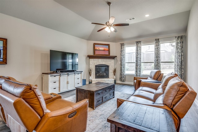 9820 Surveyor Rd, Little Elm, TX 75068 - living area with light wood-style floors, ceiling fan, vaulted ceiling, a stone fireplace, and baseboards