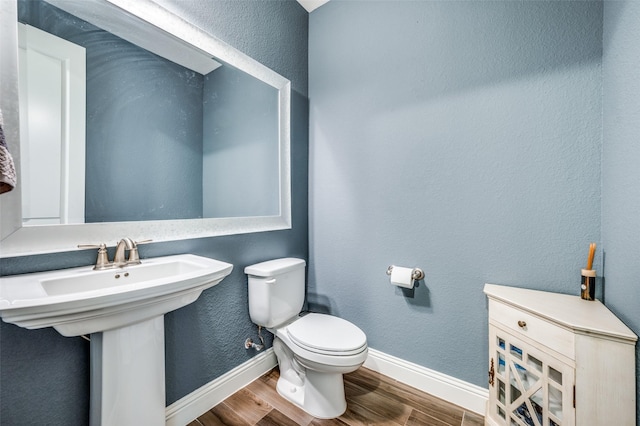 9820 Surveyor Rd, Little Elm, TX 75068 - half bath with wood finished floors, baseboards, toilet, and a sink