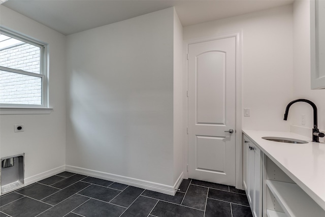 11207 Dwarfs Cir, Dallas, TX 75229 - laundry area featuring hookup for an electric dryer and dark tile patterned flooring