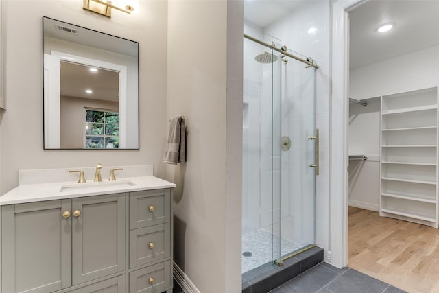 11207 Dwarfs Cir, Dallas, TX 75229 - full bath with a stall shower, a walk in closet, vanity, tile patterned flooring, and recessed lighting