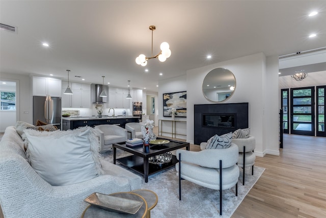 11207 Dwarfs Cir, Dallas, TX 75229 - living room with a chandelier, light wood-type flooring, recessed lighting, and healthy amount of natural light