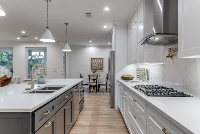11207 Dwarfs Cir, Dallas, TX 75229 - kitchen with island exhaust hood, appliances with stainless steel finishes, light countertops, white cabinetry, and decorative backsplash