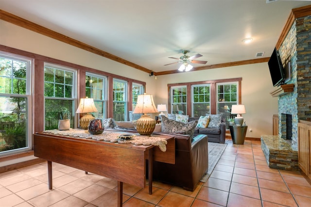 17889 County Road 134, Flint, TX 75762 - living area with light tile patterned floors, ceiling fan, a fireplace, crown molding, and baseboards