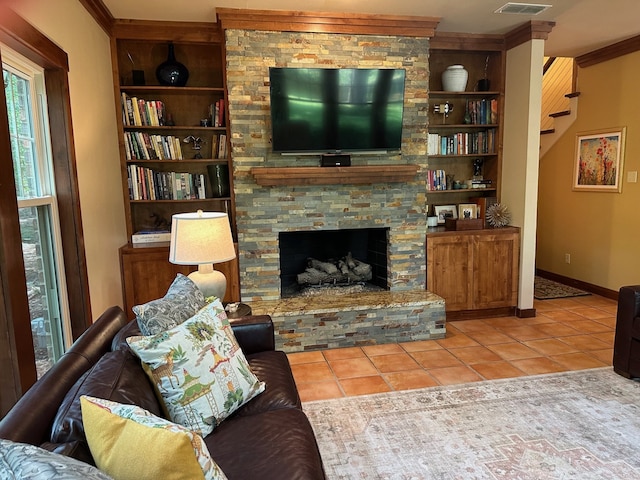 17889 County Road 134, Flint, TX 75762 - living area featuring tile patterned flooring, built in shelves, ornamental molding, a fireplace, and baseboards