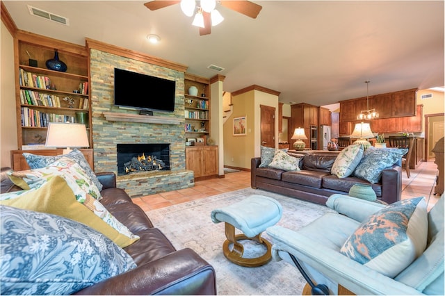 17889 County Road 134, Flint, TX 75762 - living area with a ceiling fan, built in shelves, light tile patterned flooring, a stone fireplace, and baseboards