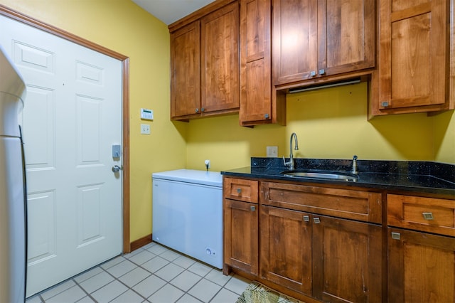 17889 County Road 134, Flint, TX 75762 - washroom featuring a sink, light tile patterned flooring, and baseboards