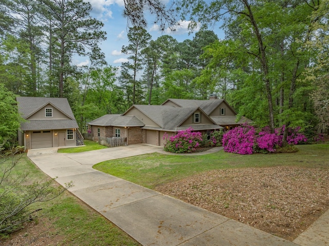 17889 County Road 134, Flint, TX 75762 - view of front of property featuring concrete driveway, a front lawn, a chimney, and view of wooded area