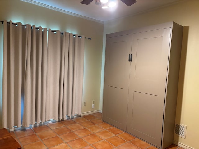 17889 County Road 134, Flint, TX 75762 - unfurnished bedroom with crown molding, light tile patterned flooring, baseboards, and a ceiling fan