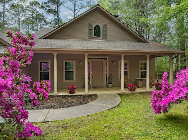 17889 County Road 134, Flint, TX 75762 - farmhouse inspired home featuring covered porch, roof with shingles, and a front yard