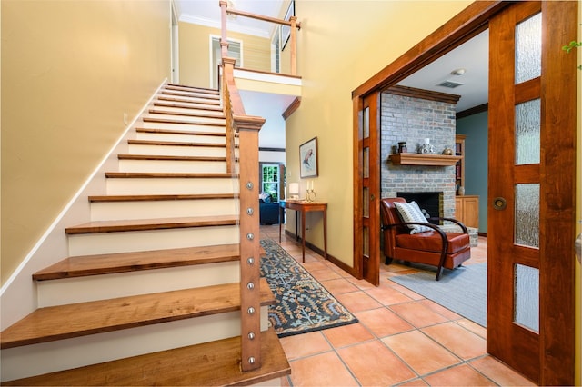 17889 County Road 134, Flint, TX 75762 - stairs with ornamental molding, tile patterned floors, and a brick fireplace
