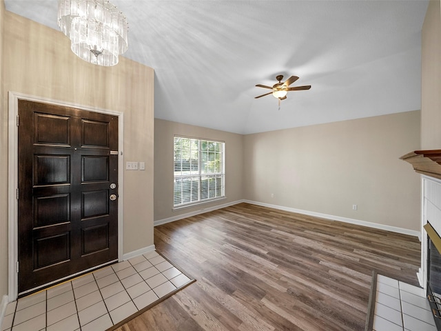 1409 Rivercrest Blvd, Allen, TX 75002 - entrance foyer featuring light wood finished floors, ceiling fan, a chandelier, a fireplace with flush hearth, and baseboards