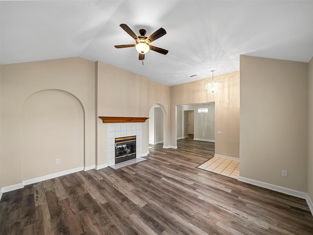 1409 Rivercrest Blvd, Allen, TX 75002 - unfurnished living room featuring ceiling fan, dark wood-style flooring, a fireplace, baseboards, and high vaulted ceiling