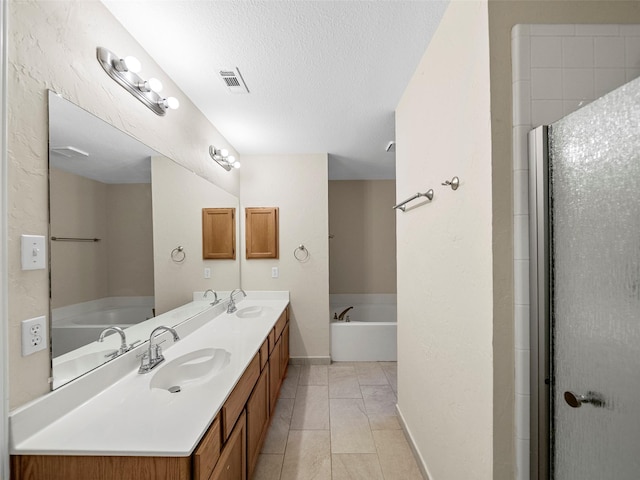 1409 Rivercrest Blvd, Allen, TX 75002 - full bathroom featuring double vanity, a garden tub, baseboards, and a textured ceiling