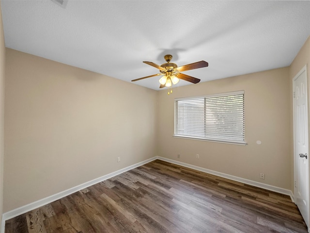 1409 Rivercrest Blvd, Allen, TX 75002 - spare room featuring dark wood-style floors, baseboards, and ceiling fan