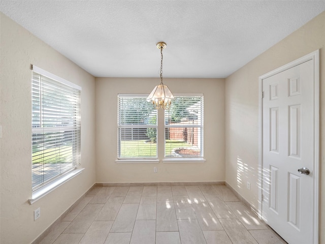 1409 Rivercrest Blvd, Allen, TX 75002 - unfurnished dining area with a chandelier, a textured ceiling, and baseboards