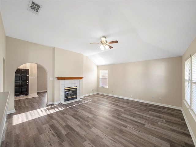 1409 Rivercrest Blvd, Allen, TX 75002 - unfurnished living room with ceiling fan, healthy amount of natural light, lofted ceiling, arched walkways, and dark wood finished floors