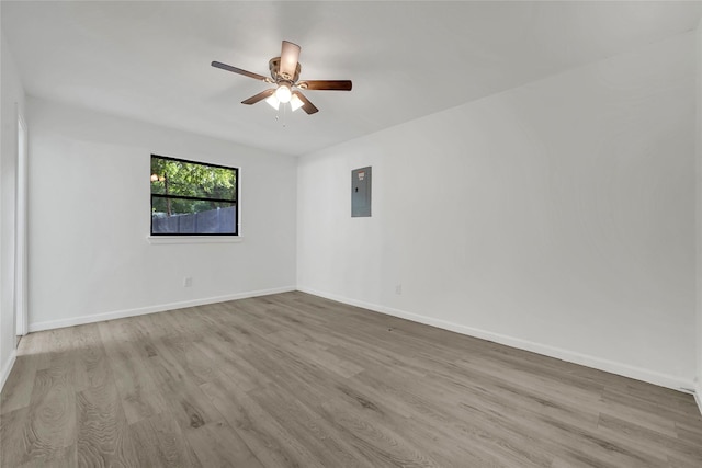 6825 John Dr, Richland Hills, TX 76118 - unfurnished room with electric panel, wood finished floors, ceiling fan, and baseboards