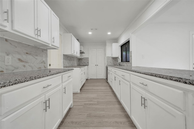6825 John Dr, Richland Hills, TX 76118 - kitchen with white cabinetry, light stone counters, recessed lighting, and decorative backsplash