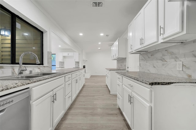 6825 John Dr, Richland Hills, TX 76118 - kitchen featuring stainless steel dishwasher, a sink, backsplash, light stone countertops, and light wood-type flooring